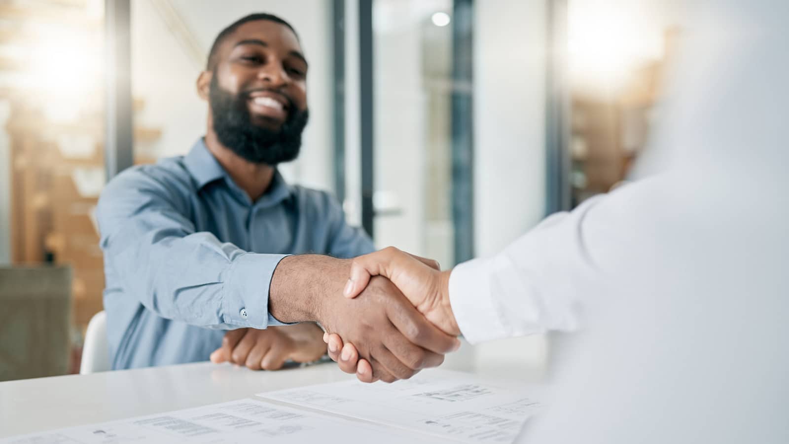 Professional man shakes someone's hand in a business exchange