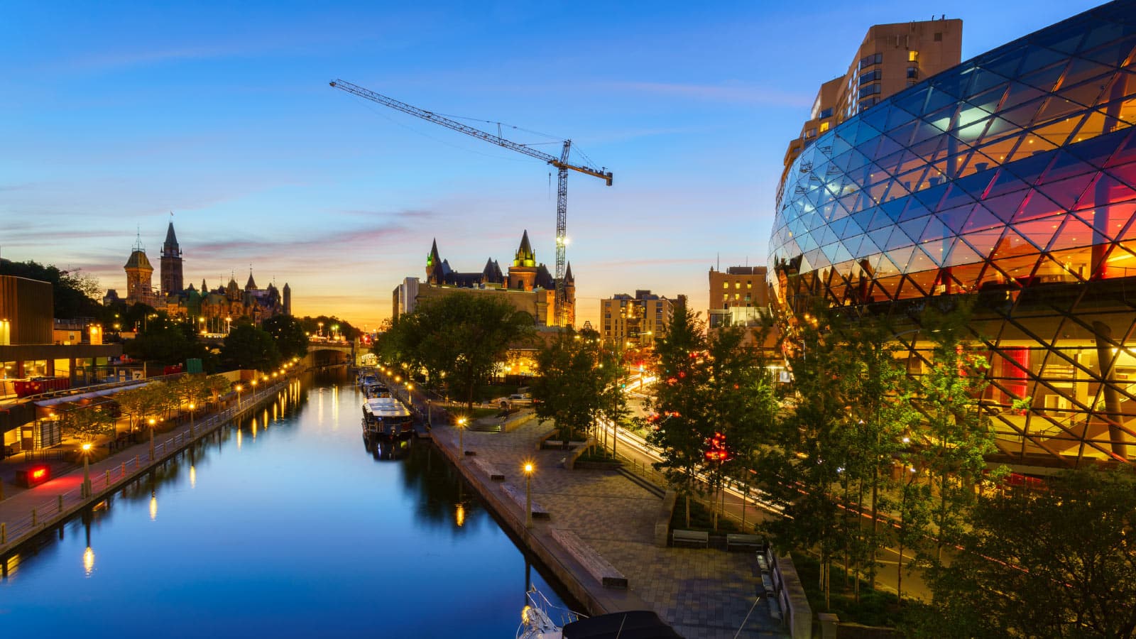Ottawa skyline with the rideau canal with a large crane in the distance